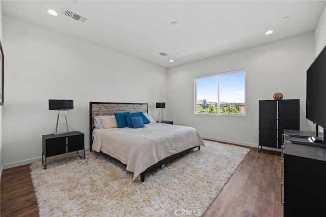 bedroom with dark hardwood / wood-style floors