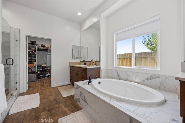 bathroom with vanity, shower with separate bathtub, and hardwood / wood-style flooring