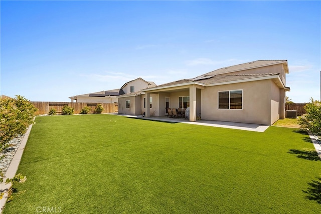 back of house featuring a patio, cooling unit, and a lawn