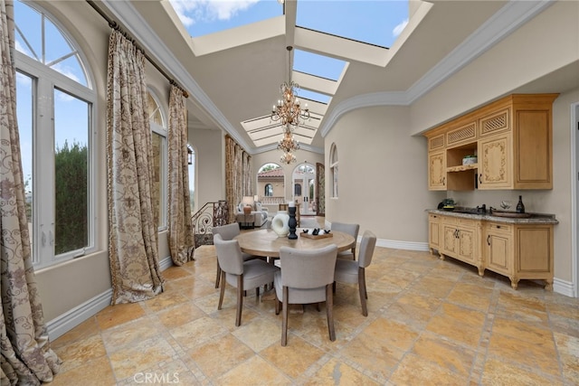 dining space with a chandelier, crown molding, high vaulted ceiling, and a skylight