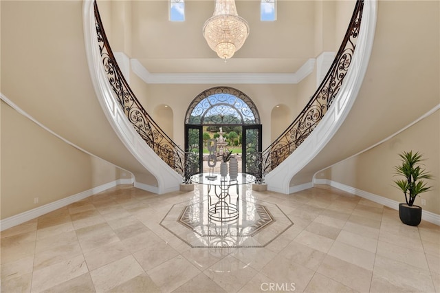 tiled entrance foyer with a towering ceiling and a notable chandelier