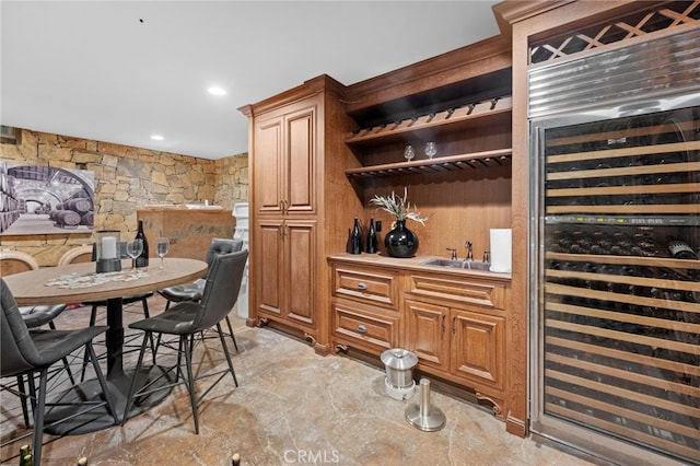 bar featuring sink and beverage cooler