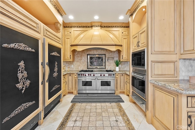 kitchen featuring backsplash, light brown cabinets, custom exhaust hood, and appliances with stainless steel finishes