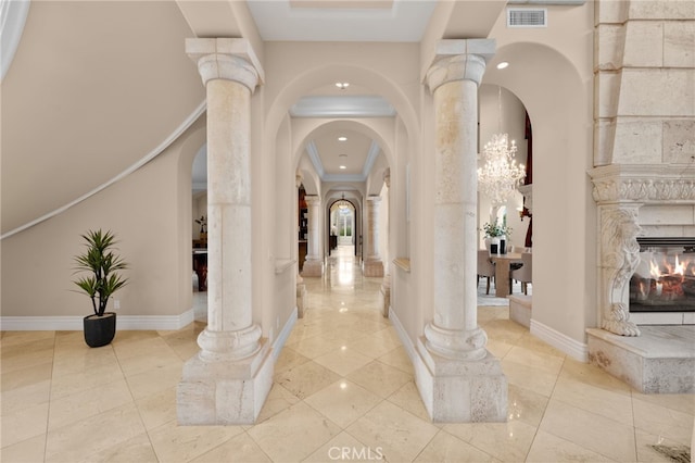 corridor with ornate columns and ornamental molding