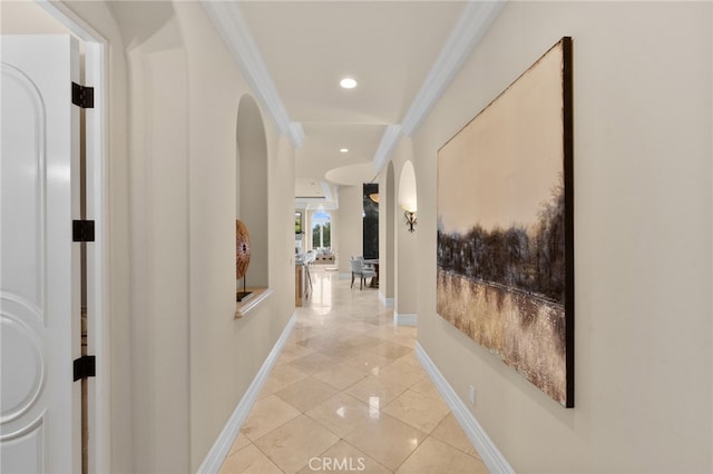 hallway with light tile patterned flooring and ornamental molding