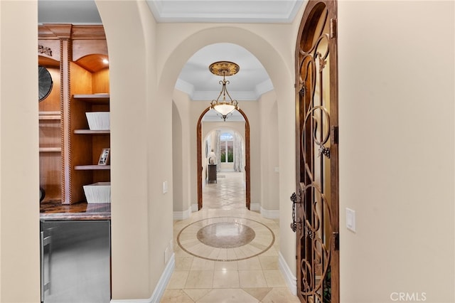 hallway with crown molding and light tile patterned flooring