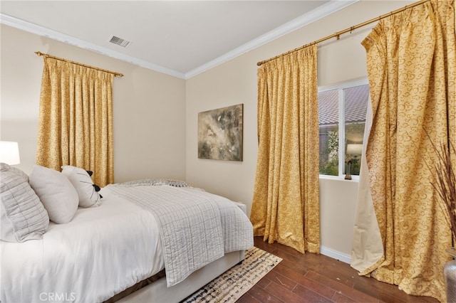 bedroom featuring dark hardwood / wood-style floors and ornamental molding