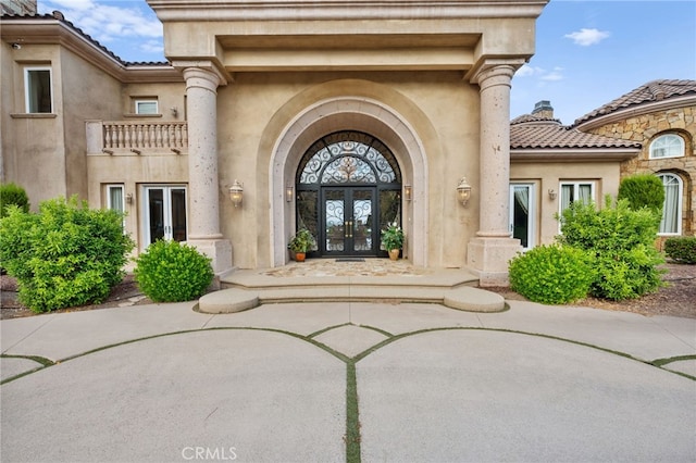 entrance to property with a balcony and french doors