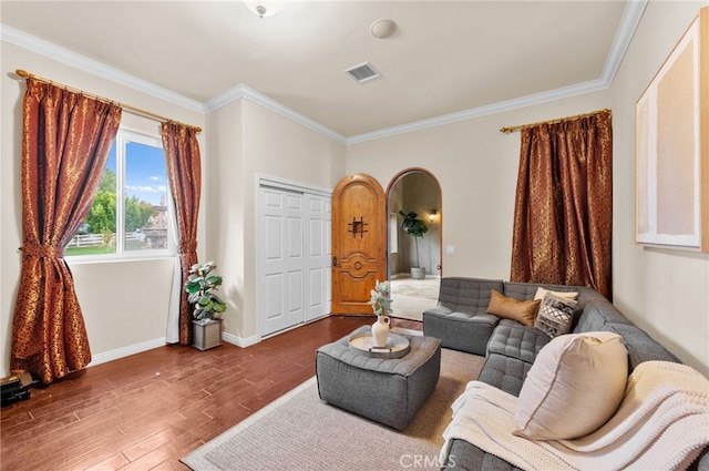 living room with wood-type flooring and ornamental molding