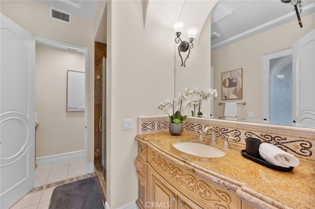 bathroom with tile patterned flooring, vanity, and a shower with shower door