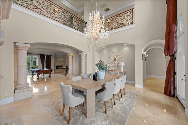 tiled dining space with pool table, crown molding, a high ceiling, and a chandelier