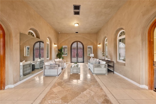 entryway with french doors and light tile patterned flooring