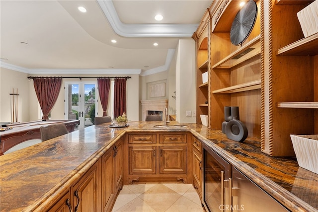 bar featuring sink, french doors, beverage cooler, light tile patterned flooring, and ornamental molding