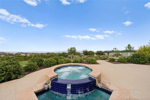 view of swimming pool with an in ground hot tub and pool water feature