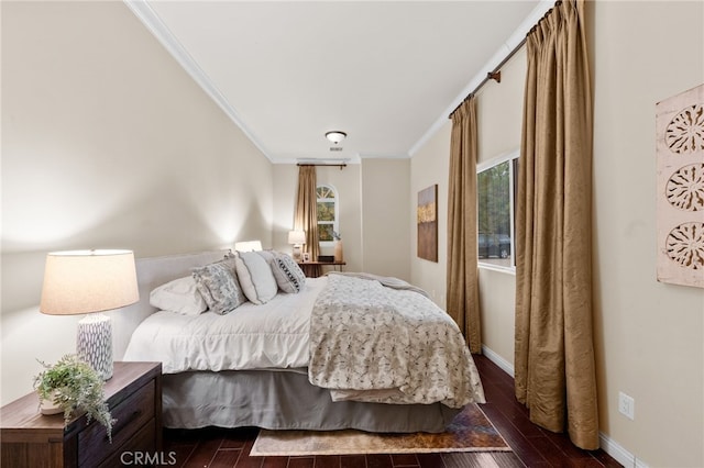 bedroom featuring crown molding and dark wood-type flooring