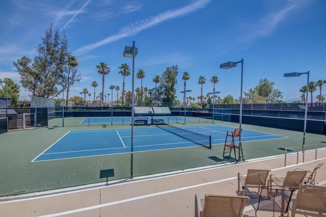 view of tennis court featuring basketball hoop