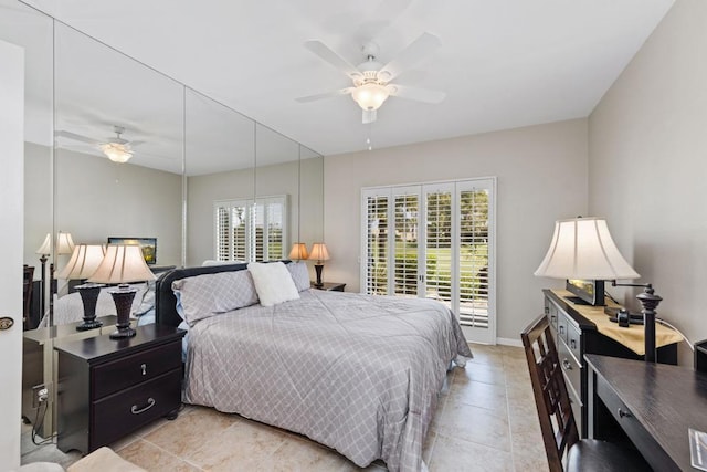 bedroom with ceiling fan, light tile patterned floors, and multiple windows