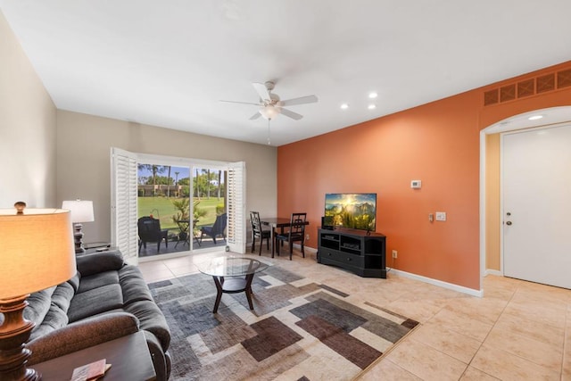 tiled living room featuring ceiling fan