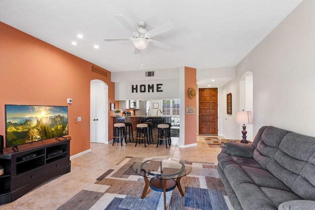 tiled living room with ceiling fan