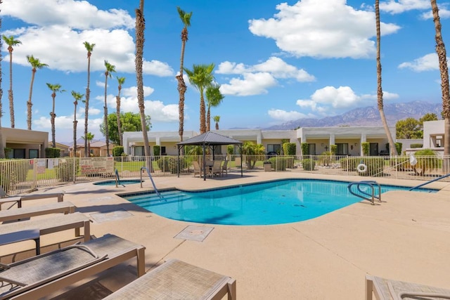 view of pool with a mountain view and a patio area