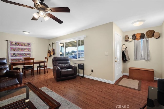 living room featuring dark hardwood / wood-style flooring and ceiling fan