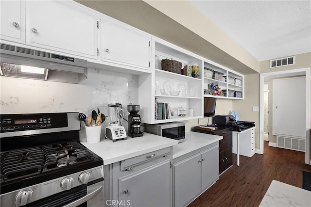 kitchen featuring stainless steel appliances, white cabinetry, dark hardwood / wood-style floors, and range hood