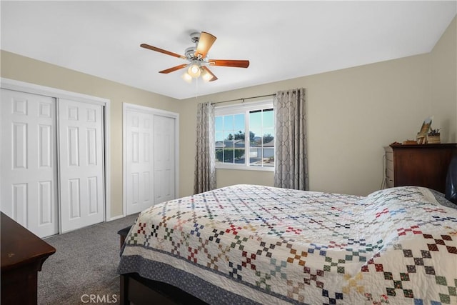 bedroom featuring carpet flooring, ceiling fan, and two closets