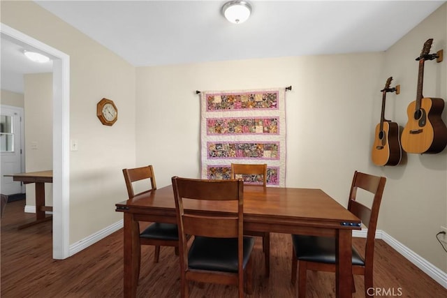 dining room with dark hardwood / wood-style floors