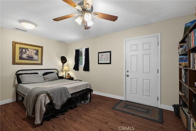 bedroom with ceiling fan and dark wood-type flooring