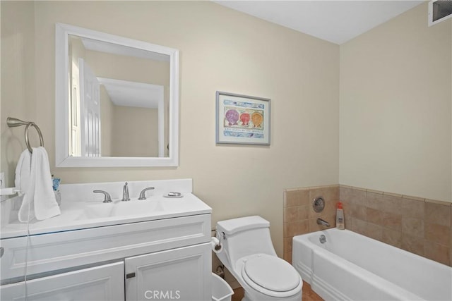 bathroom with vanity, toilet, and a bath