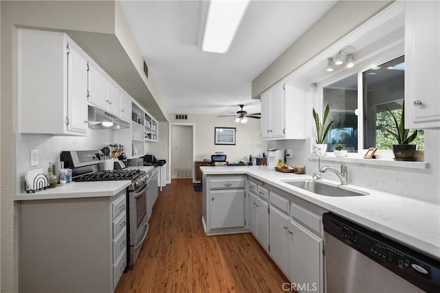 kitchen featuring hardwood / wood-style flooring, sink, white cabinets, and appliances with stainless steel finishes