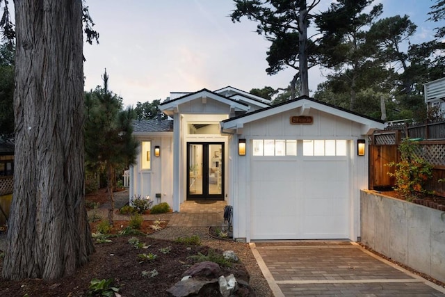 view of front of house with a garage and french doors