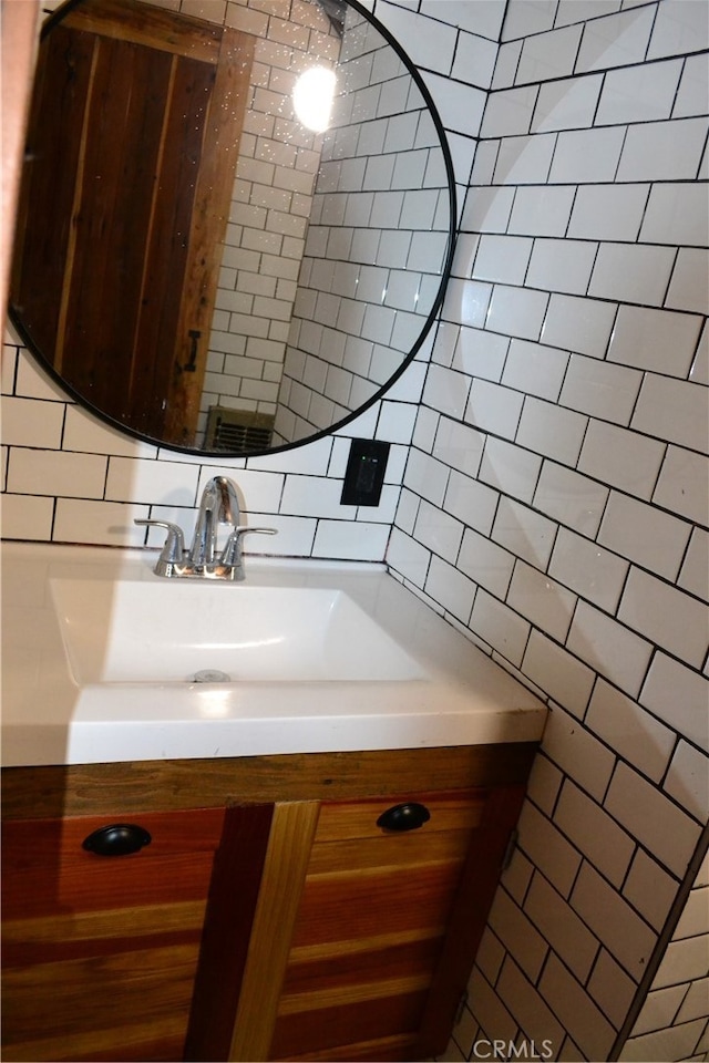 bathroom featuring vanity, tile walls, and backsplash