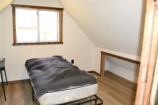 bedroom featuring vaulted ceiling and hardwood / wood-style floors