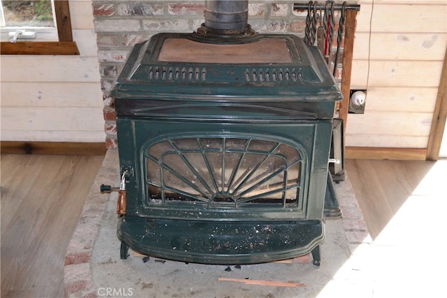 room details featuring a wood stove and hardwood / wood-style floors