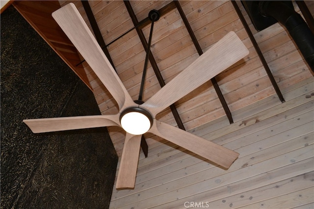 details featuring beam ceiling, wood ceiling, and wood walls