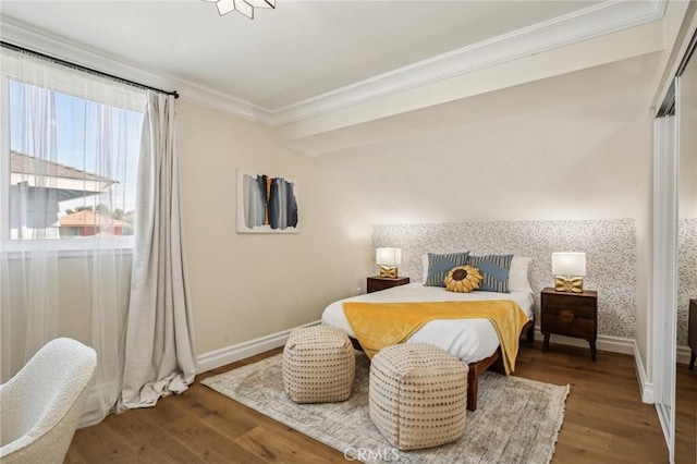 bedroom featuring ornamental molding and dark wood-type flooring