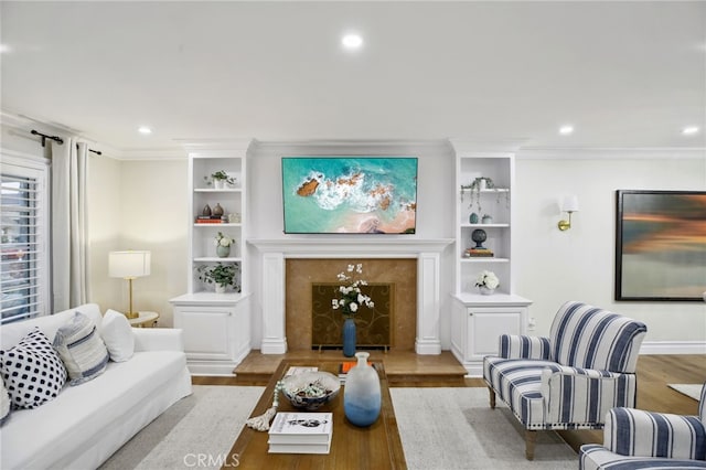 living room featuring hardwood / wood-style floors, a premium fireplace, and crown molding