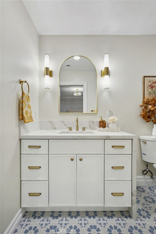 bathroom featuring tile patterned floors, vanity, and toilet