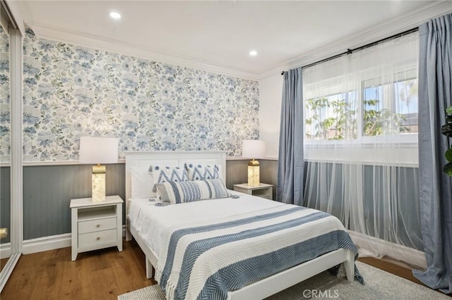 bedroom with dark hardwood / wood-style flooring and crown molding