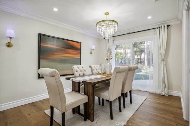 dining room featuring hardwood / wood-style floors, an inviting chandelier, and ornamental molding