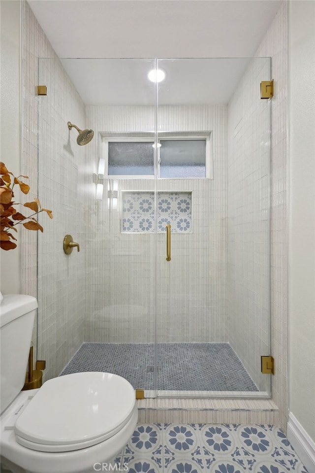 bathroom with tile patterned flooring, an enclosed shower, and toilet