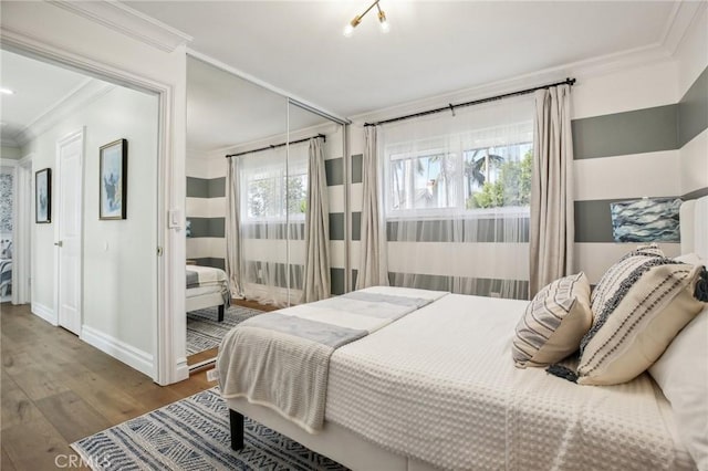 bedroom featuring hardwood / wood-style floors and crown molding