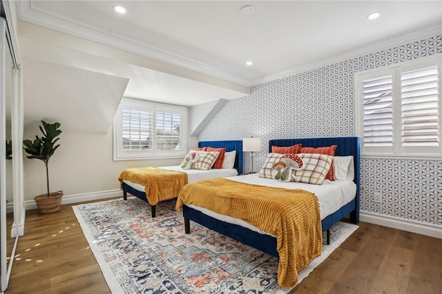 bedroom with dark hardwood / wood-style floors and ornamental molding