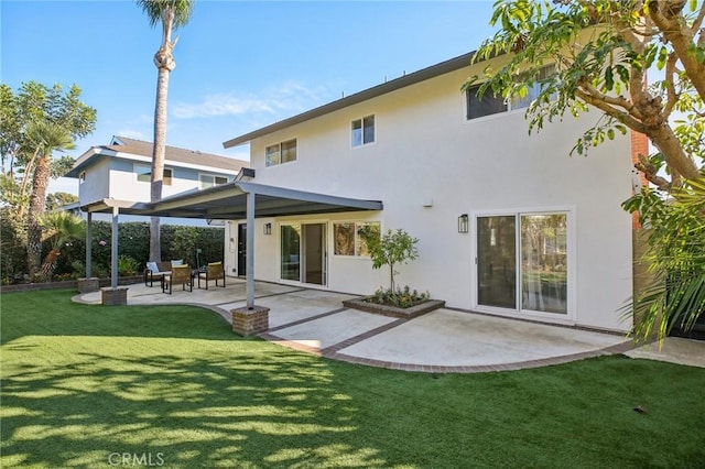 back of property featuring a yard and a patio