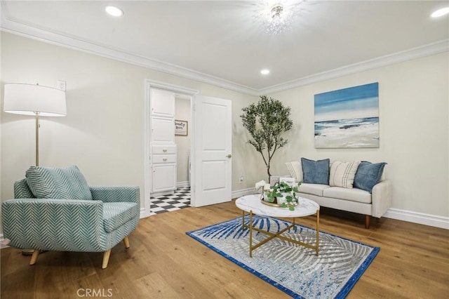 sitting room with hardwood / wood-style flooring and ornamental molding