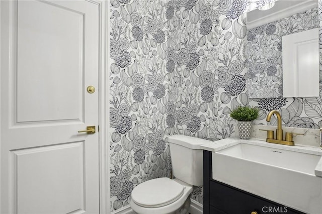 bathroom with crown molding, vanity, and toilet