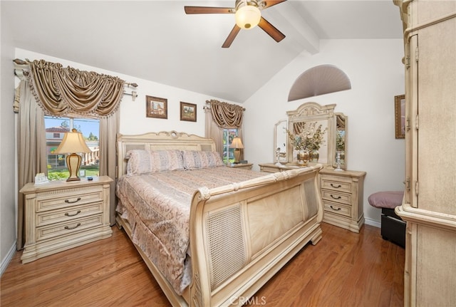 bedroom featuring hardwood / wood-style flooring, ceiling fan, and vaulted ceiling with beams