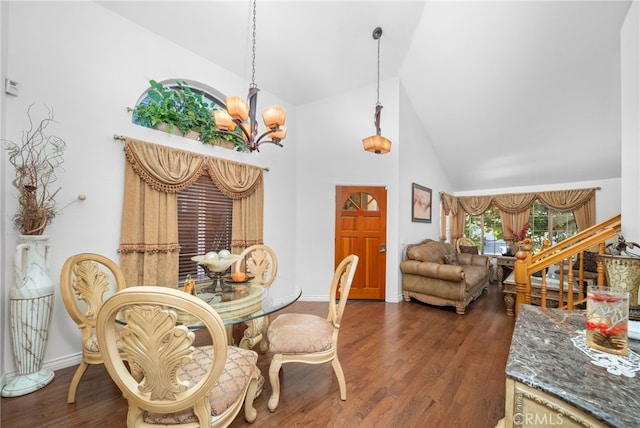 dining room featuring dark wood-type flooring, a chandelier, and high vaulted ceiling