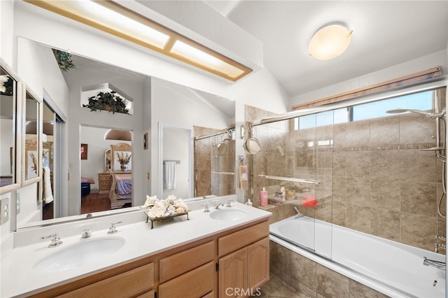 bathroom featuring enclosed tub / shower combo, vanity, and vaulted ceiling